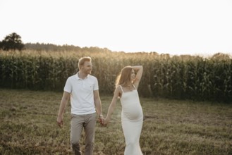 Pregnant, young woman with partner