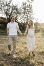 Pregnant, young woman with partner