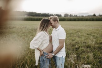 Pregnant, young woman with partner