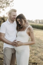 Pregnant, young woman with partner