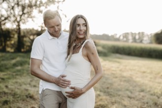 Pregnant, young woman with partner