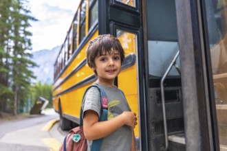 Preschool student with backpack embarking on a yellow school bus, excited for the new academic