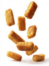 Deep-fried, greasy breaded fish fingers fall onto the background against a white background, crispy