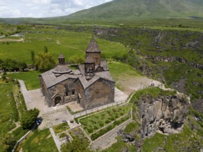 Stone church building in a green and rocky landscape, aerial view, Saghmosavank Monastery,