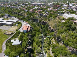 Urban view with a river surrounded by houses and a rocky gorge, aerial view, Kassagh River,