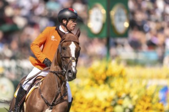 Willem Greve of the Netherlands, riding Pretty Woman Van't Paradujs, competes in the first round of