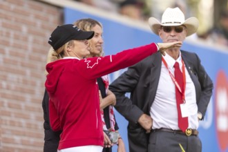 Tiffany Foster, Amy Millar and Chef d'Equipe, Ian Millar from Team Canada watch Susan Horn compete