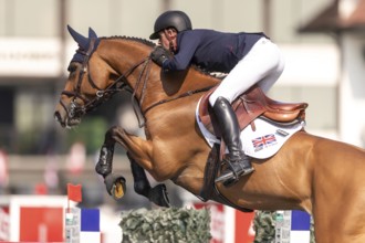 Ben Maher of England, riding Enjeu De Grisien, competes in the first round of the 2025 BMO Nations