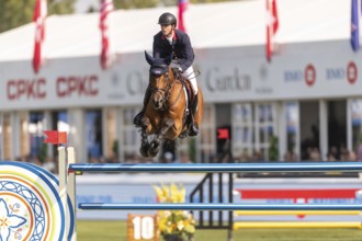 Ben Maher of England, riding Enjeu De Grisien, competes in the first round of the 2025 BMO Nations