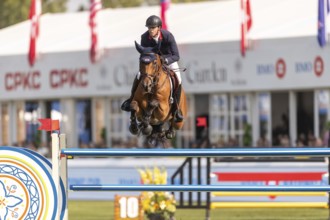 Ben Maher of England, riding Enjeu De Grisien, competes in the first round of the 2025 BMO Nations