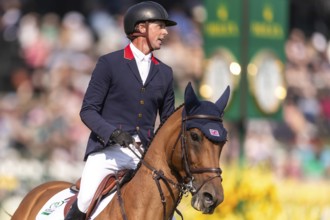 Ben Maher of England, riding Enjeu De Grisien, competes in the first round of the 2025 BMO Nations