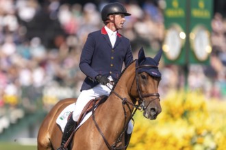 Ben Maher of England, riding Enjeu De Grisien, competes in the first round of the 2025 BMO Nations
