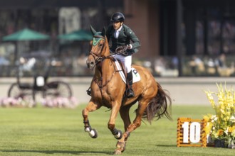Gabriel De Matos Machado of Brazil, riding Nyles Van de Mottelhoeve, competes in the first round of