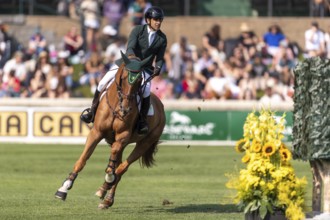 Gabriel De Matos Machado of Brazil, riding Nyles Van de Mottelhoeve, competes in the first round of