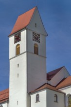 Church tower with gabled roof and clock, parish church of St Lawrence from 1404 in Leupolz in