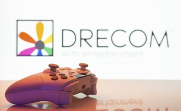 Dhaka, Bangladesh- 13 Sep 2025: A close-up of a white gamepad with the Drecom seen on screen in the