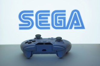 Dhaka, Bangladesh- 13 Sep 2025: A close-up of a white gamepad with the Sega seen on screen in the