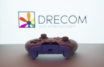 Dhaka, Bangladesh- 13 Sep 2025: A close-up of a white gamepad with the Drecom seen on screen in the