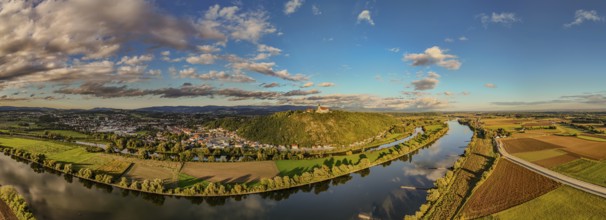 A picturesque landscape shows the Danube meandering through the green surroundings. Hills and