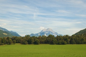 Wide green meadows with mountains in the background under a clear sky, Admont, Styria, Austria