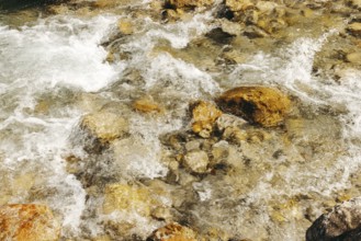 Clear water streams of the Johnsbach flow over rocky stones, Gesäuse, Styria, Austria