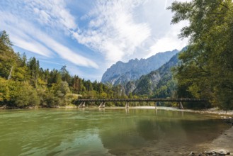 Wooden bridge over the Enns with stony bank and Reichenstein group in the background, Gesäuse,