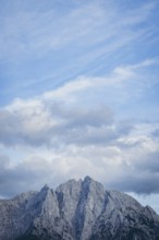 Imposing mountain peak of the Ödstein against a cloudy blue sky, Gesäuse, Styria, Austria