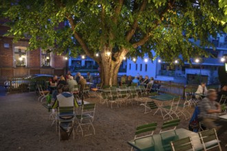 Illuminated garden restaurant in the evening, Erlangen, Middle Franconia, Bavaria, Germany