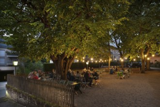 Illuminated garden restaurant in the evening, Erlangen, Middle Franconia, Bavaria, Germany