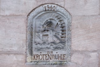 Relief of the former toad mill from 1340 on a house wall on the Pegnitz, Karlsbrücke, Nuremberg