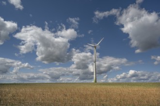 Stubble field, wind turbine and cloudy sky, Karsberg, Upper Franconia, Bavaria, Germany