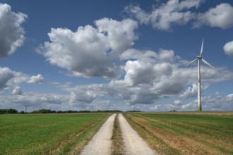 Field path and wind turbine in Franconian landscape, Karsberg, Upper Franconia, Bavaria, Germany