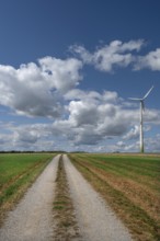Field path and wind turbine in Franconian landscape, Karsberg, Upper Franconia, Bavaria, Germany