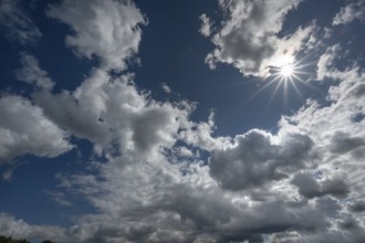 Cloudy sky with sun star, Bavaria, Germany