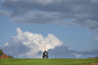 Tower of a chapel behind a meadow hill, cloudy sky, Köttweinsdorf, Upper Franconia, Bavaria,