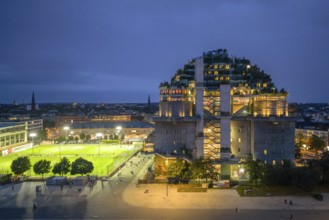 Aerial view of the Hamburg bunker on Heiligengeistfeld during the blue hour with illuminated floors