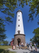Tourists stand in front of the Lange Erik lighthouse, Langer Erik, on the northern tip of the