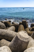 Coastal fortification at the beacon to the harbour entrance on the kilometre-long beach Praia da