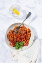 Bigos, Polish dish bigos, on a marble table, stewed meat with cabbage, chorizo sausages, mushrooms,
