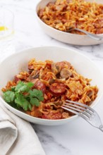Bigos, Polish dish bigos, on the table, pan with stewed meat, with cabbage, chorizo sausages,