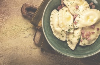 Dumplings, with fried prosciutto, a traditional dish of Polish cuisine, dumplings, top view,