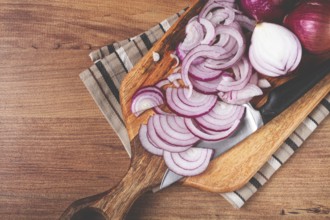 Sliced red onion, on a chopping board, with a knife, Spanish onion, raw onion, close-up, top view