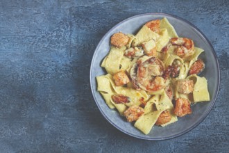 Papardelle pasta in creamy sauce with seafood, homemade, no people