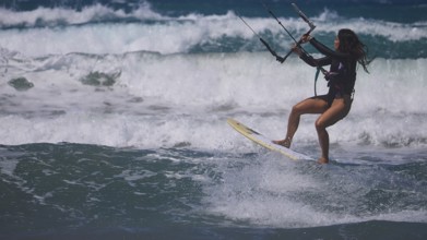 Woman kitesurfing sportily over the waves under a clear sky, Prasonisi, beach, surf, windsurfer,