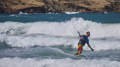 Kitesurfer riding elegant waves in sunny weather and blue sea, Prasonisi, beach, surf, windsurfer,