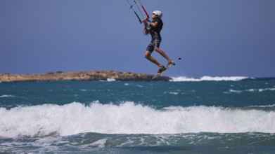 Kitesurfer in the air jumping over the waves in sunny weather, Prasonisi, beach, surf, windsurfer,