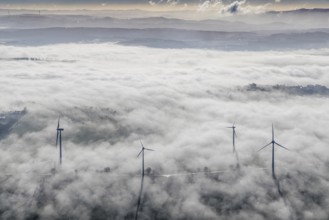 Aerial view, wind turbines in the fog and mountains of the Sauerland in the backlight in the