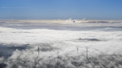 Aerial view, wind turbines in the fog and mountains of the Sauerland in the backlight in the