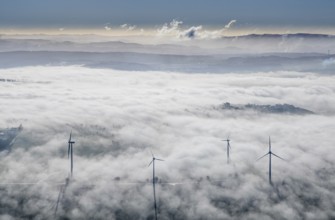 Aerial view, wind turbines in the fog and mountains of the Sauerland in the backlight in the