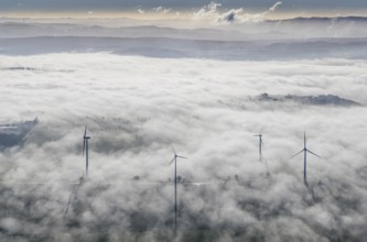 Aerial view, wind turbines in the fog and mountains of the Sauerland in the backlight in the